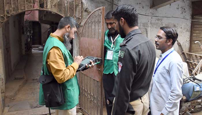 An official from the Pakistan Bureau of Statistics uses a digital device to collect information from a resident during door-to-door the first ever digital national census in Karachis Old City area on March 3, 2023. — Online