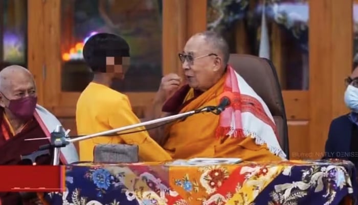 In this still from a video, the spiritual leader can be seen asking the boy to “suck his tongue”. — Business Today