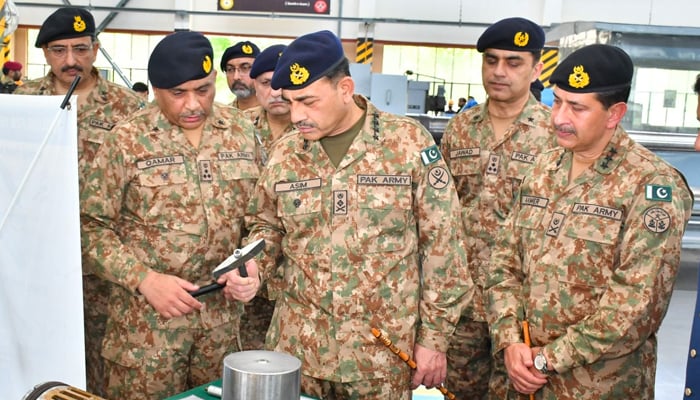COAS General Asim Munir looks at products at the Heavy Industries Taxila (HIT) on April 11, 2023. — ISPR