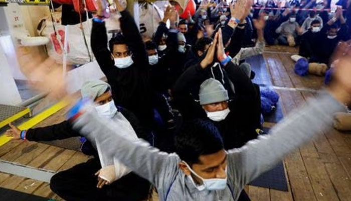 Migrants react as they wait to disembark the Geo Barents rescue ship, operated by Medecins Sans Frontieres (Doctors Without Borders), in Bari, Italy March 26, 2023. —Reuters