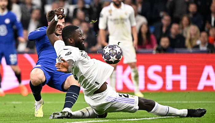 Real Madrids German defender Antonio Rudiger vies with Chelsea´s English midfielder Mason Mount (back) during the UEFA Champions League quarter final first leg football match between Real Madrid CF and Chelsea FC at the Santiago Bernabeu stadium in Madrid on April 12, 2023. AFP