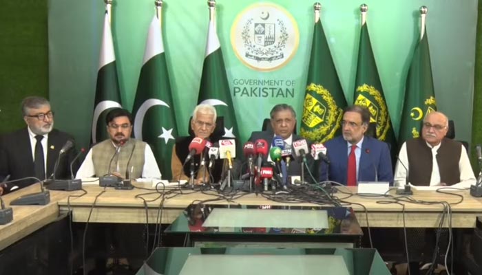 Law Minister Azam Nazeer Tarar (C) addresses a press conference along with Adviser to PM Qamar Zaman Kaira (R) in Islamabad, on April 13, 2023, in this still taken from a video. — YouTube/PTVNews