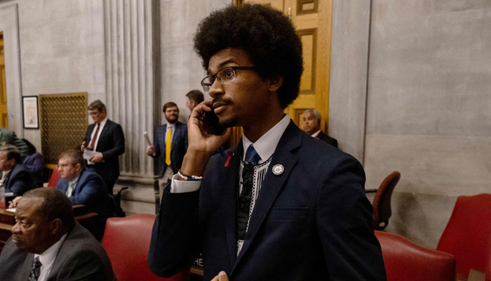 Democratic state Rep. Justin Pearson of Memphis speaks on his phone while being expelled from the state Legislature on April 6, 2023, in Nashville, Tennessee. — AFP
