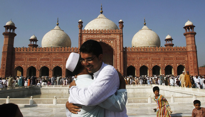 An undated image of people hugging each other after Eid prayers. —APP/File