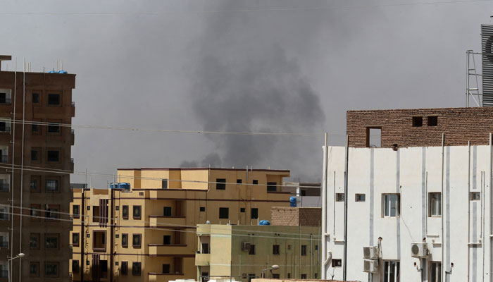 Smoke rises above buildings in Khartoum on April 15, 2023. Sudanese paramilitaries said on April 15 that the regular army has entered their camps in south Khartoum and laid siege to paramilitary forces there. — AFP