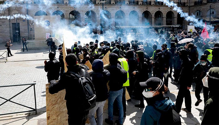 Protestors clash with police officers during a demonstration against the French Government´s pension reform hours after it was signed into law in Rennes, western France, on April 15, 2023.