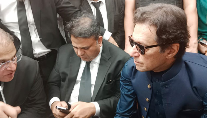 Pakistan Tehreek-e-Insaf (PTI) Chairman Imran Khan talking to his lawyer after his arrival at Lahore High Court on April 17, 2023. — Twitter/PTI