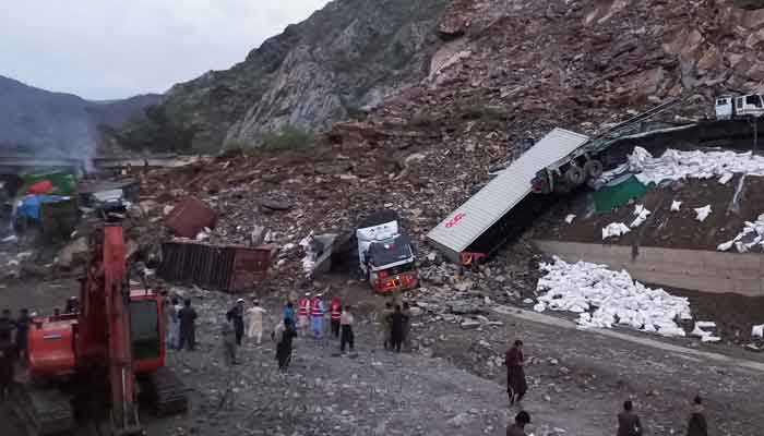 Rescue workers and people gather after trucks loaded with supplies were trapped in a landslide on the road close to the Torkham border, Pakistan April 18, 2023. —Reuters