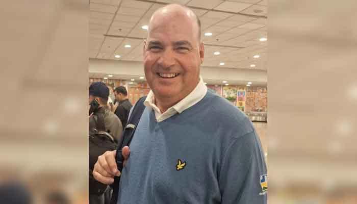 Former head coach Mickey Arthur smiles for the camera as he arrives in Islamabad on April 18, 2023. — PCB