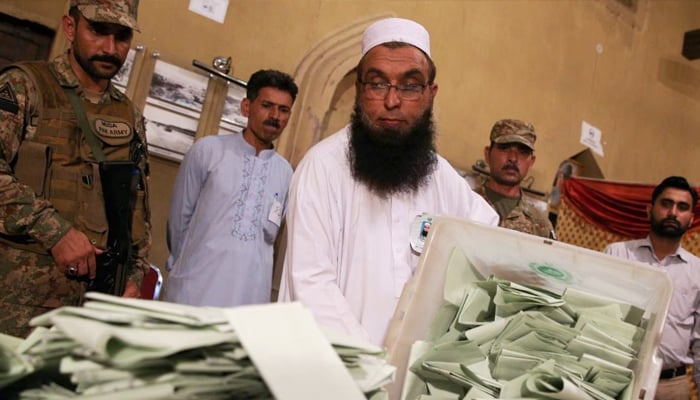 Polling staff counting ballots during an election in this undated photo. — Reuters/File