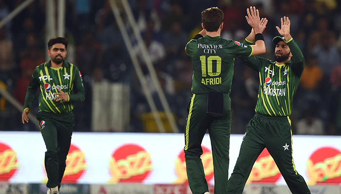 Pakistans Shaheen Shah Afridi (centre) celebrates with teammate Iftikhar Ahmed (right) after taking the wicket of New Zealands Daryl Mitchell (not pictured) during the third Twenty20 international cricket match between Pakistan and New Zealand at the Gaddafi Cricket Stadium in Lahore on April 17, 2023. — AFP
