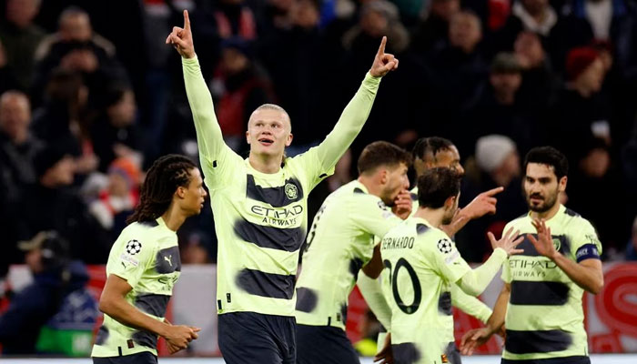 Manchester Citys Erling Braut Haaland celebrates scoring their first goal with teammates. Reuters