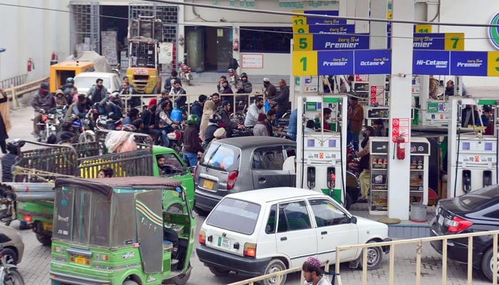 A view of motorists standing in a queue for filling petrol outside a petrol pump in Rawalpindi on January 1, 2023. — Online