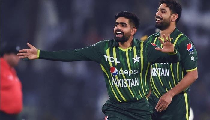 Pakistans captain Babar Azam (L) and teammates Haris Rauf celebrate after the dismissal of New Zealands Mark Chapman (not pictured) during the first T20 cricket match between Pakistan and New Zealand at the Gaddafi Cricket Stadium in Lahore on April 14, 2023. — AFP