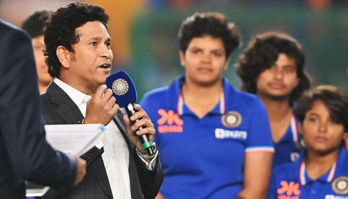 Former Indian cricketer Sachin Tendulkar congratulates the womens Under-19 cricket team, who just won the Twenty20 cricket World Cup in South Africa, before the start of the third Twenty20 international cricket match between India and New Zealand at the Narendra Modi stadium in Ahmedabad on February 1, 2023. — AFP