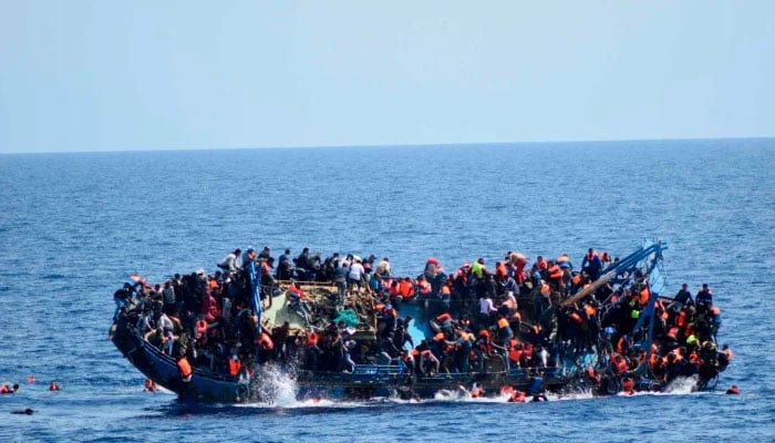 The shipwreck of an overcrowded boat of migrants off the Libyan coast as seen in a handout picture released by the Italian Navy (Marina Militare) on May 25, 2016.-AFP