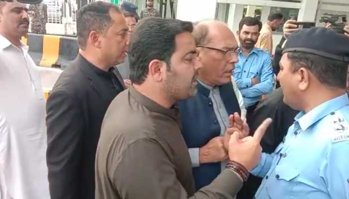 PTI lawmakers argue with Islamabad police personnel outside the main entrance of the parliament building on April 26, 2023, in this still from video.  — Geo news
