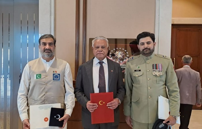 Head of the Alkhidmat Foundation team (left) poses after receiving the honour. — Alkhidmat Foundation