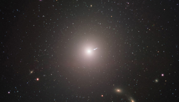 The supermassive black hole imaged by the EHT is located in the centre of the elliptical galaxy M87, located about 55 million light-years from Earth. This image was captured by FORS2 on ESOs Very Large Telescope. The short linear feature near the centre of the image is a jet produced by the black hole. — NASA/File