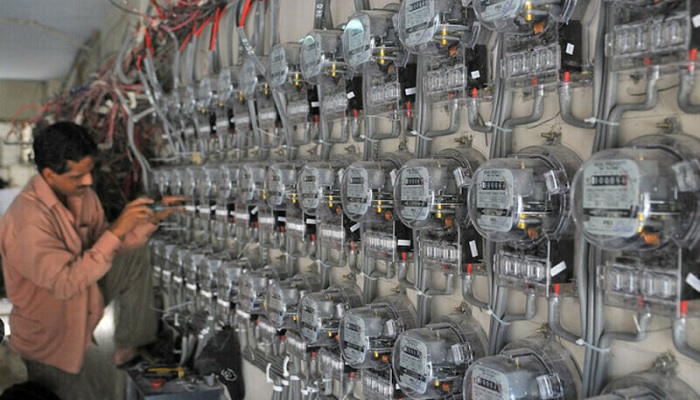 A technician works on new electricity metres at a residential multi-apartment building in Karachi. —AFP/File