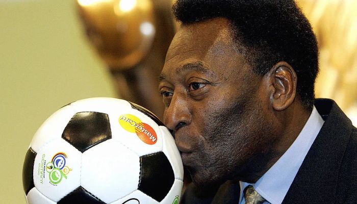 The image shows Pele kissing a football.— AFP/file
