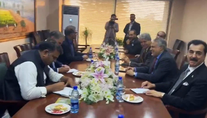 PTI (left) and PDM delegations during a meeting at Parliament House in Islamabad, on April 27, 2023, in this still taken from a video. — Geo.tv via Haider Sherazi