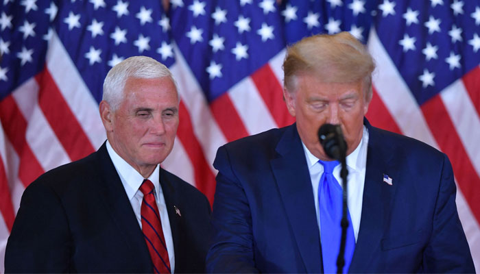 Former US vice president Mike Pence (L) listens as former US President Donald Trump speaks during election night in the East Room of the White House in Washington, DC. — AFP/File