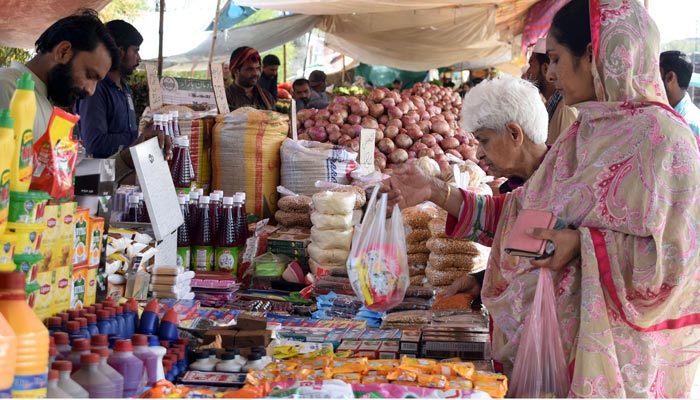 People are buying grocery from stalls at weekly Sunday Market in Lahore on April 2, 2023. — Online