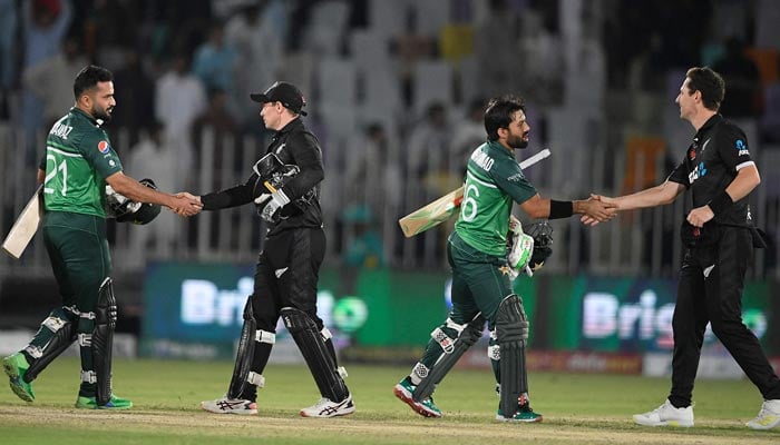 Pakistans Mohammad Rizwan (2nd R) shakes hands with New Zealands Matt Henry (R) alongside Mohammad Nawaz (L) and New Zealand´s captain Tom Latham (2nd L) after Pakistans victory during the first ODI cricket match between Pakistan and New Zealand at the Rawalpindi Cricket Stadium in Rawalpindi, on April 27, 2023. — AFP