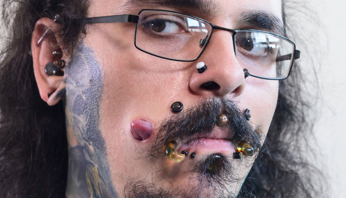 British man breaks Guinness World Record with 17 face flesh tunnels