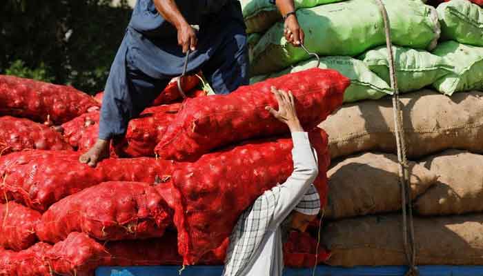 Labourers unload sacks of onion from a truck to supply at a market in Karachi, Pakistan February 1, 2023. — Reuters