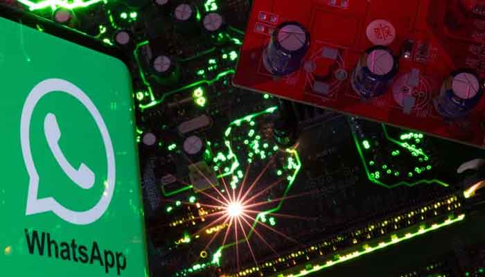 A smartphone with a displayed WhatsApp logo is placed on a computer motherboard in this illustration taken February 23, 2023. — Reuters