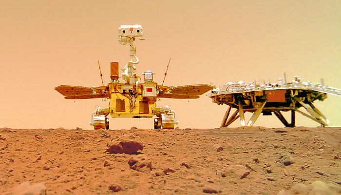 A picture of Chinas Mars rover and the landing platform on Mars. A tiny picture of the 2022 Winter Games mascots is shown next to the Chinese national flag on the front of the landing platform. — China National Space Administration/File