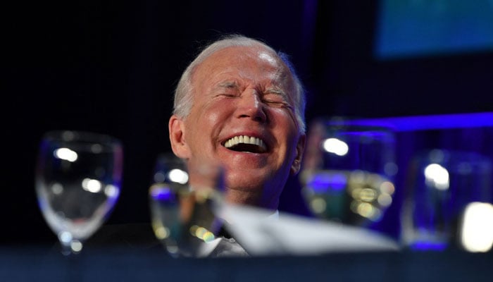 US President Joe Biden laughs during the White House Correspondents Association gala at the Washington Hilton Hotel in Washington, DC, on April 29, 2022. — AFP
