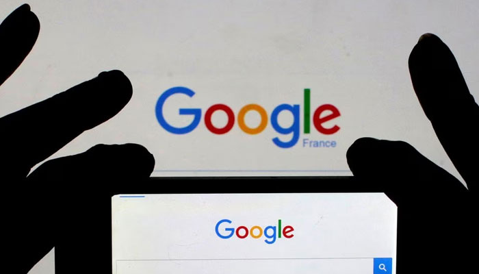 A woman holds her smartphone, which displays the Google home page, in this picture illustration. — Reuters/File
