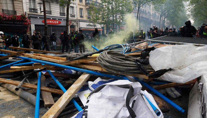 Ransacked materials from a construction site lie spread across the street during a demonstration on May Day. — AFP