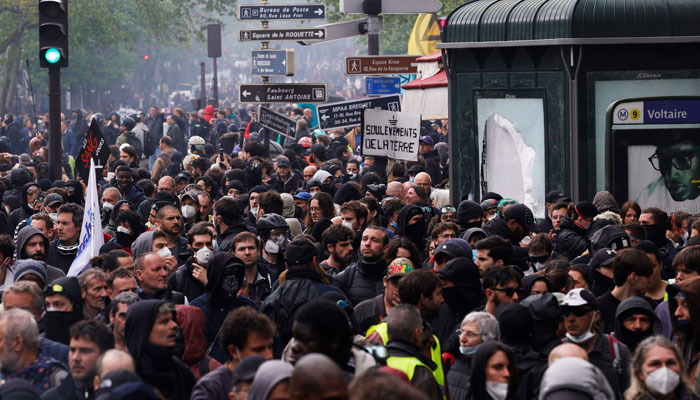 Protesters take part in a demonstration on May Day (Labour Day), to mark the international day of the workers, more than a month after the government pushed an unpopular pensions reform act through parliament, in Paris, on May 1, 2023. — AFP