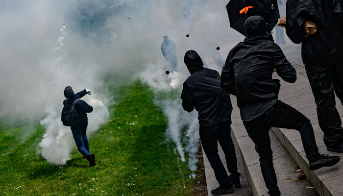 Masked protesters clash with anti-riot police officers during a demonstration on May Day in Nantes, northwestern France, on May 1, 2023. — AFP