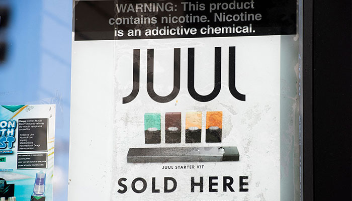 (FILES) In this file photo taken on September 17, 2019 a sign advertises Juul vaping products in Los Angeles, California. Juul agreed to pay $462 million to six states and the District of Columbia to settle charges that it violated numerous laws in marketing tobacco products to youth, prosecutors said April 12, 2023.