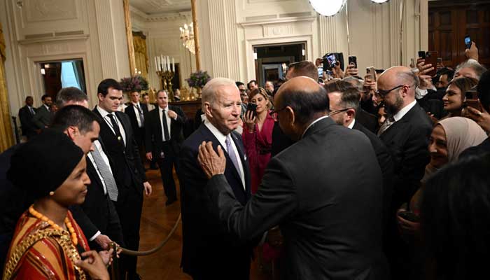 US President Joe Biden greets attendees during a reception celebrating Eid-al-Fitr, marking the end of the Muslim fasting month of Ramadan, in the East Room of the White House in Washington, DC, on May 1, 2023. — AFP