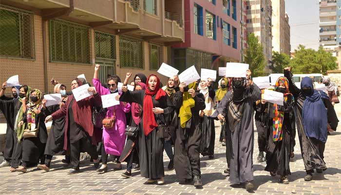 Afghan women hold placards as they march to protest for their rights, in Kabul on April 29, 2023. — AFP