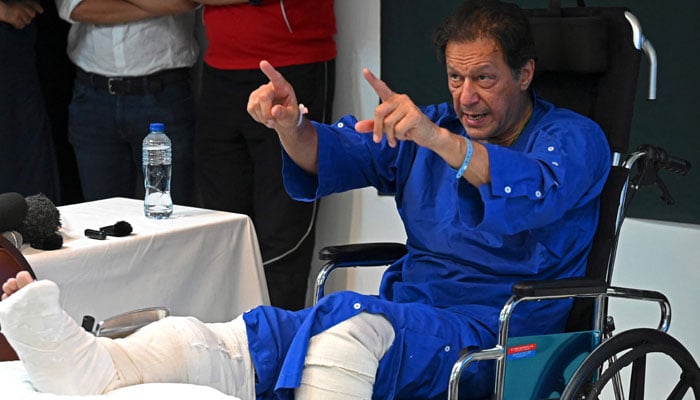 In this photo taken on November 4, 2022, Imran Khan addresses media representatives at a hospital in Lahore, a day after an assassination attempt against him.  — AFP
