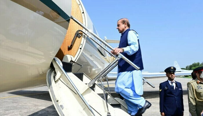 Prime Minister Muhammad Shehbaz Sharif climbs into a plane in this undated photo. — Twitter/@pmln_org