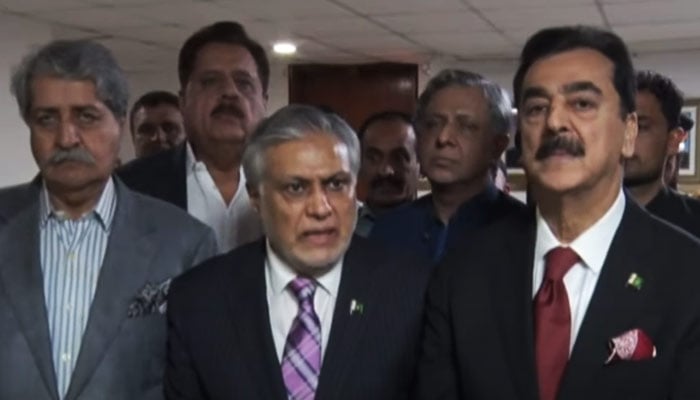 Finance Minister Ishaq Dar (centre) addressing a press conference alongside a government delegation at the Parliament House in Islamabad, on May 3, 2023, in this still taken from a video. — YouTube/PTVNewsLive
