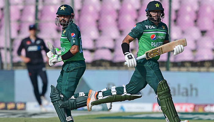 Pakistan´s captain Babar Azam (L) and Imam-ul-Haq run between the wickets during the third one-day international (ODI) cricket match between Pakistan and New Zealand at the National Stadium in Karachi on May 3, 2023. — AFP