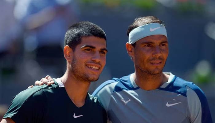Carlos Alcaraz (left) with Rafael Nadal before their Madrid Open quarter-final clash on May 6, 2022. — AFP