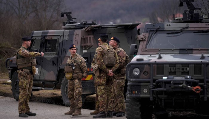 NATO peacekeeping soldiers patrol near the town of Zvecan in Kosovo on Dec. 29. — AFP