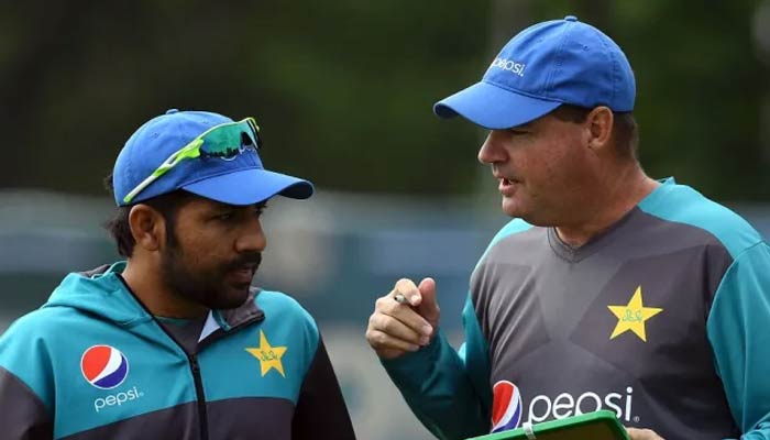 Former skipper Sarfraz Ahmed (left) chats with Mickey Arthur on May 31, 2017. — AFP