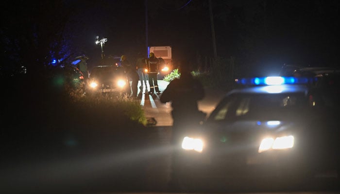 Police block the road near the village of Malo Orasje, just outside the town of Mladenovac, about 60 kilometres (37 miles) south of Serbias capital Belgrade, on May 5, 2023, in the aftermath of a drive-by shooting. — AFP