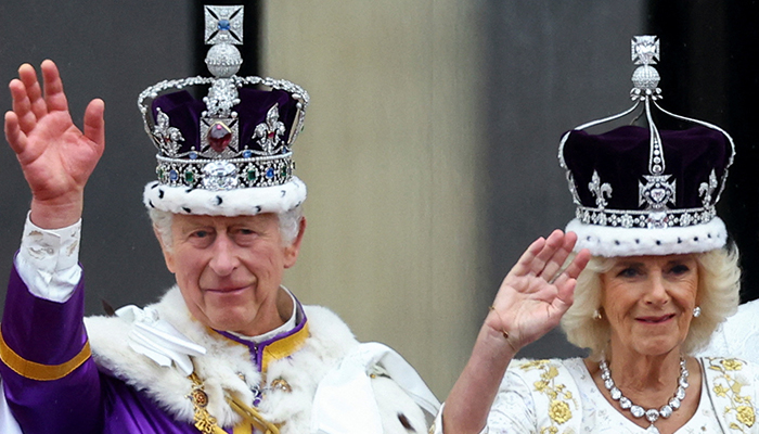 Britains King Charles and Queen Camilla gesture as they stand on the Buckingham Palace balcony following their coronation ceremony in London, Britain May 6, 2023. — Reuters